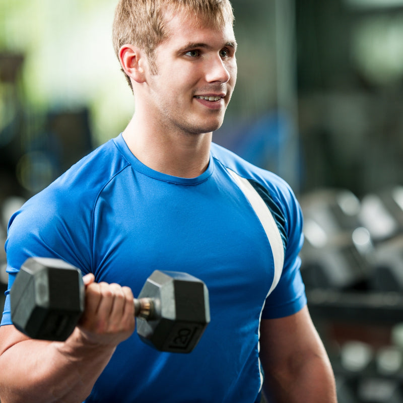 Man lifting dumbbells in a gym setting