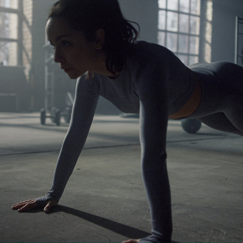 Person in a plank position in a dimly lit room